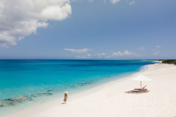 Person standing on Malcolm's Road Beach at Amanyara