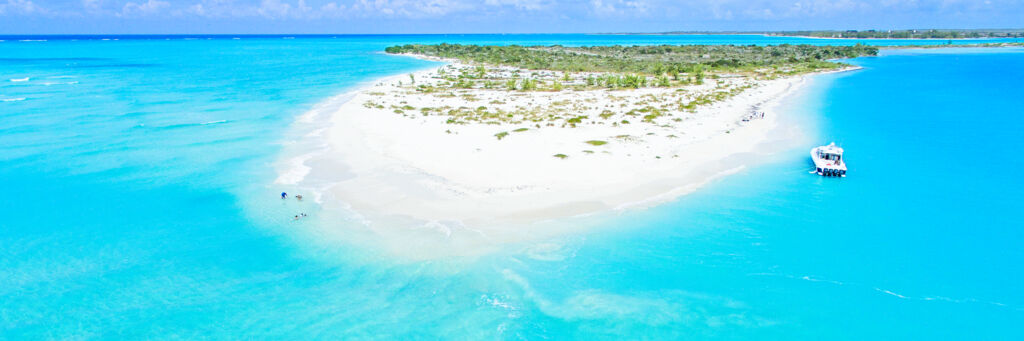 Aerial view of the sand spit at Fort George Cay and a boat