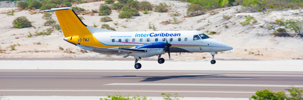 InterCaribbean twin-engine turbo prop aircraft landing at Providenciales International Airport