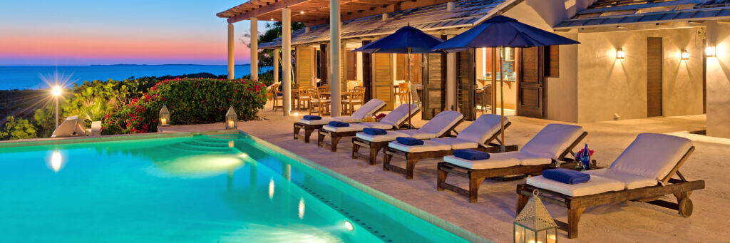 Pool terrace at a villa at dusk