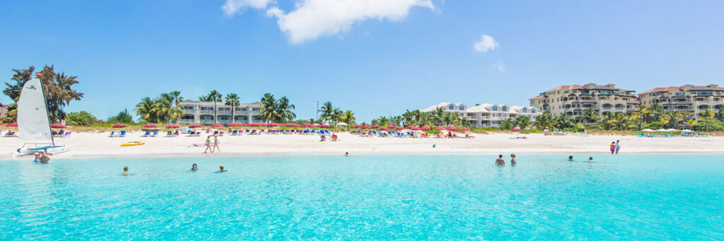 People enjoying the spectacular Grace Bay Beach in the Turks and Caicos