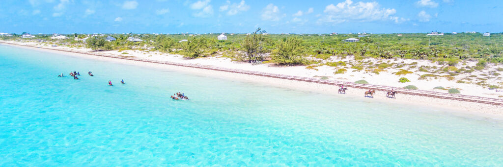 Horseback riding in the turquoise water at Long Bay Beach on Providenciales