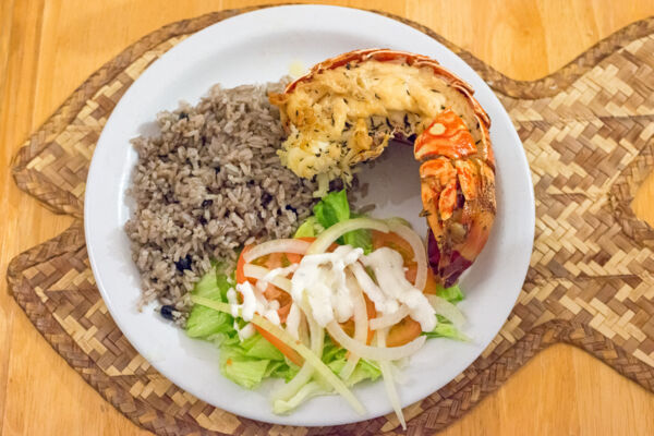 Spiny lobster tail, peas and rice, and salad dinner at Daniel's Cafe on Middle Caicos