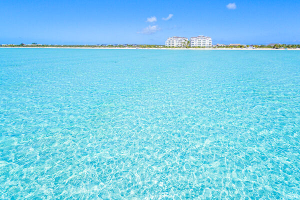 Aerial view of clear ocean water and The Shore Club resort at Long Bay Beach