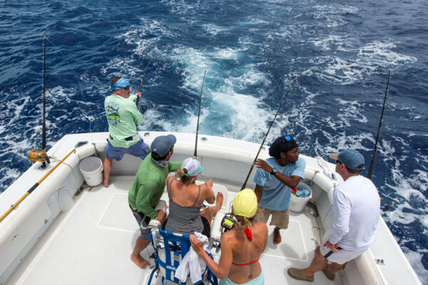 Reeling in fish on a deep sea sport fishing charter