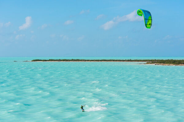 Beautiful turquoise water and kiteboarder at West Harbour Bluff on Providenciales